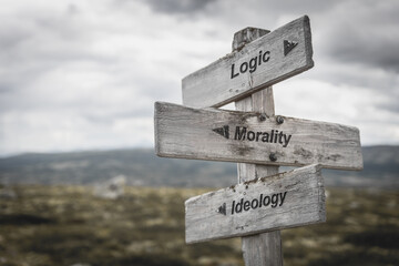 logic morality ideology text on wooden sign outdoors. - obrazy, fototapety, plakaty