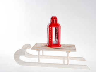 Red Christmas lantern on a sled..Concept for postcard, congratulations, Merry Christmas. There is space for text