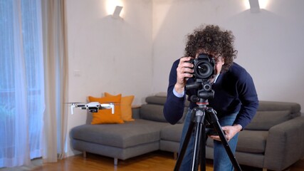 A photographer uses a drone for surveying, photography and video of apartment and building...