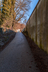 Walking path and trees and an archway in a park in Salzburg