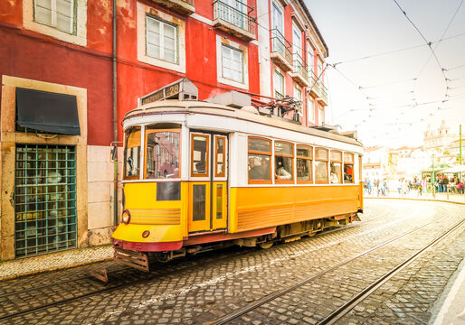 tram on narrow street of Alfama, Lisbon © neirfy