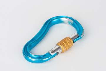 Used blue HMS  carabiner, screw lock snap hook, climbing  equipment on white background.