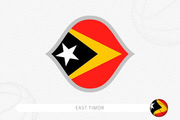 East Timor flag for basketball competition on gray basketball background.