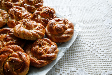 Homemade traditional cinnamon - cardamom sweet buns, close up view. Traditional Swedish baking Kanelbular.