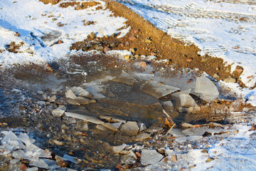 Garbage in frozen mud and snow
