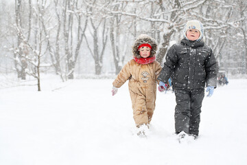 Boy and girl walking in winter park