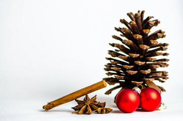 Christmas decorations for card. Pine cone, cinnamon, red christmas balls of red and gold color. Close-up. Macro. Xmas 