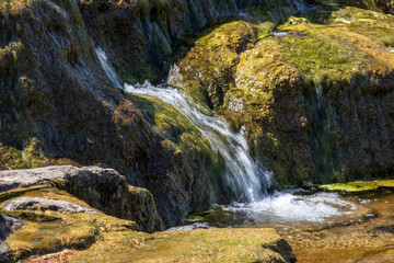 Swimming in the waterfall in the mountains