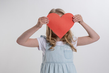 Beautiful girl holding a heart in her hands