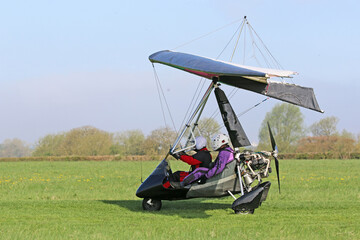 Ultralight airplane taxiing on a farm strip	