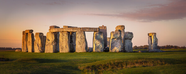 Beautiful panorama of Stonehenge during early morning. Sunrise glow seen on the historical landmark