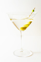 martini glass with olives in vertical orientation with white background.