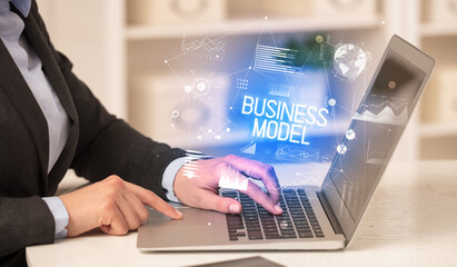 Side view of a business person working on laptop