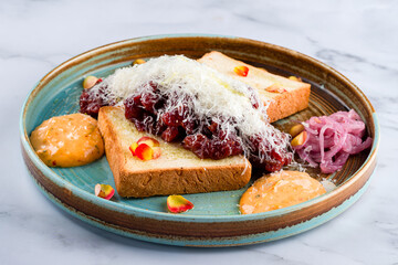 Close up view on served Steak beef tartare served with bread, sauce and salad. Restaurant food menu. European cuisine