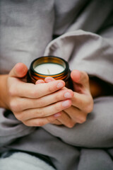 a candle in the hands of a girl close-up