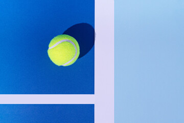 Tennis ball on pastel blue background. Challenge inspiration. Minimal flat lay design. Champion...