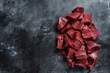 Raw sliced Beef or veal heart. Black background. Top View. Copy space