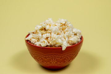 A ceramic bowl of salted popcorn