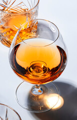 Strong drinks, spirits and distillates in glasses: cognac, whiskey and other in assortment. White...