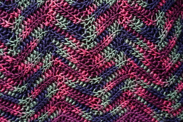 Crochet in Zig Zag Pattern from Purple Navy and Green Variagated Yarn as Background