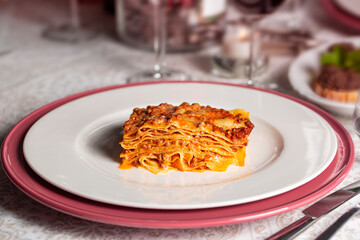 Served portion of homemade lasagna with meat and tomato ragù sauce, bechamel and parmesan cheese...