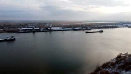 Amazing river. One barge is sailing along the river. Nice dark color correction. Beautiful sky at sunset. The night bank of the river. Russia, The Don