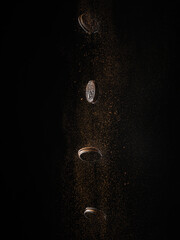 Creative composition - chocolate chip cookies and chocolate dust, a crumb in a state of levitation on a black background. Sweet food, patisserie, restaurant, cookbook, food blog.