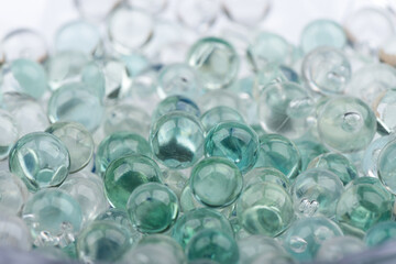 Full frame of glass marbles with blurred front and back marbles.