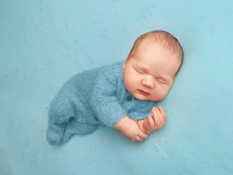 newborn little boy. first photo session of a newborn. baby on a blue background