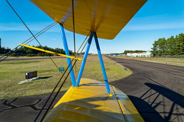 The runway viewed through the wings of a biplane at the airport in Florence, Oregon, USA