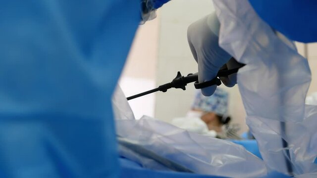 Doctor surgeon manages laparoscopy during a surgical operation to remove a cancerous tumor. Medicine, cancer control and prevention.