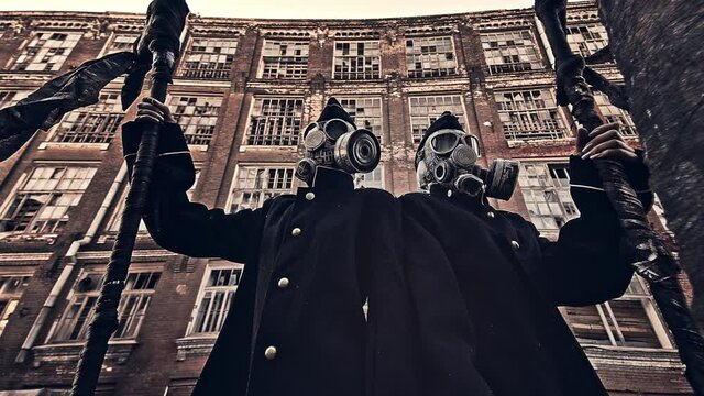 Soldiers in gas masks on the background of buildings.