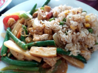 Chicken breasts in soy sauce and stir-fry satay vegetables fried rice