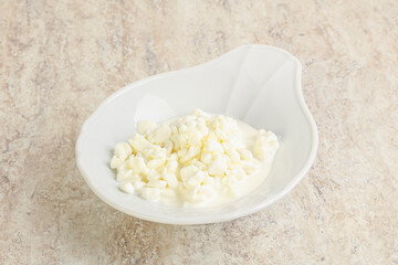 Grained cottage cheese in the bowl