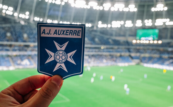 September 12, 2021, Auxerre, France. The emblem of the football club AJ Auxerre against the background of the modern stadium.