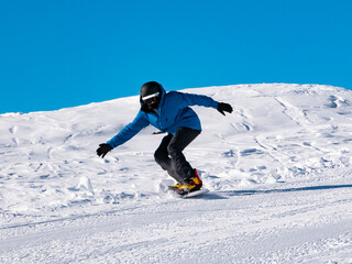 Fototapeta na wymiar Snowboarder on a ski slope
