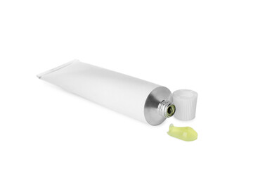 Open tube with ointment on white background