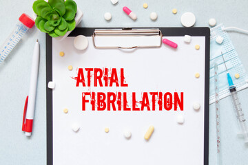 Medicine and health concept. An alarm clock, pills, injections and a card with the inscription - Atrial Fibrillation.