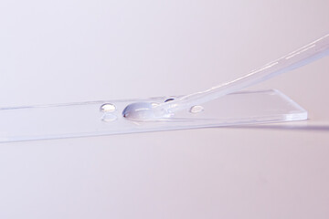 glass and syringe with clear solution 