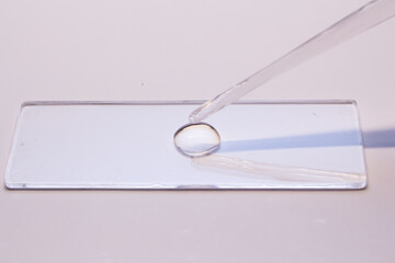 glass and syringe with clear solution 