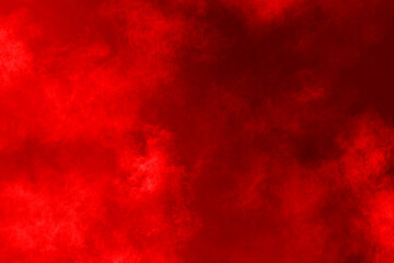 Red powder explosion on red background.