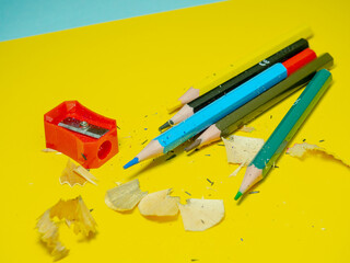 School supplies. Pencil sharpening. Pencil sharpener . Multicolored pencils.   The process of...