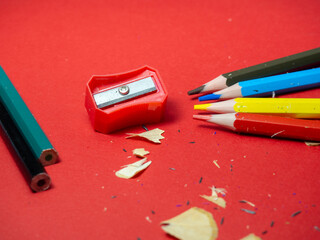 School supplies. Pencil sharpening.  Multicolored pencils. Wood shavings. The process of preparing...