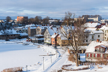 Top view of Talsi city and lake on a snowy winter day