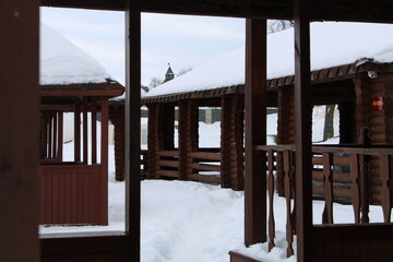 brown wooden gazebo covered with snow