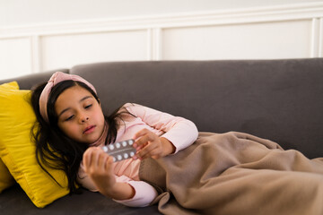 Little kid holding a blister pack