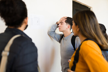 Worried student looking at his final grades