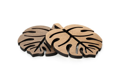 Leaf shaped wooden cup coasters on white background
