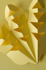 abstract composition with cut paper in yellow