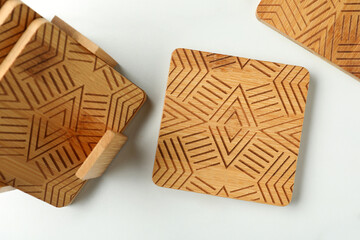 Stylish wooden cup coasters on white table, flat lay